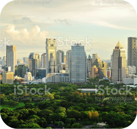 A panoramic view of Bangkok cityscape with a park in the center.